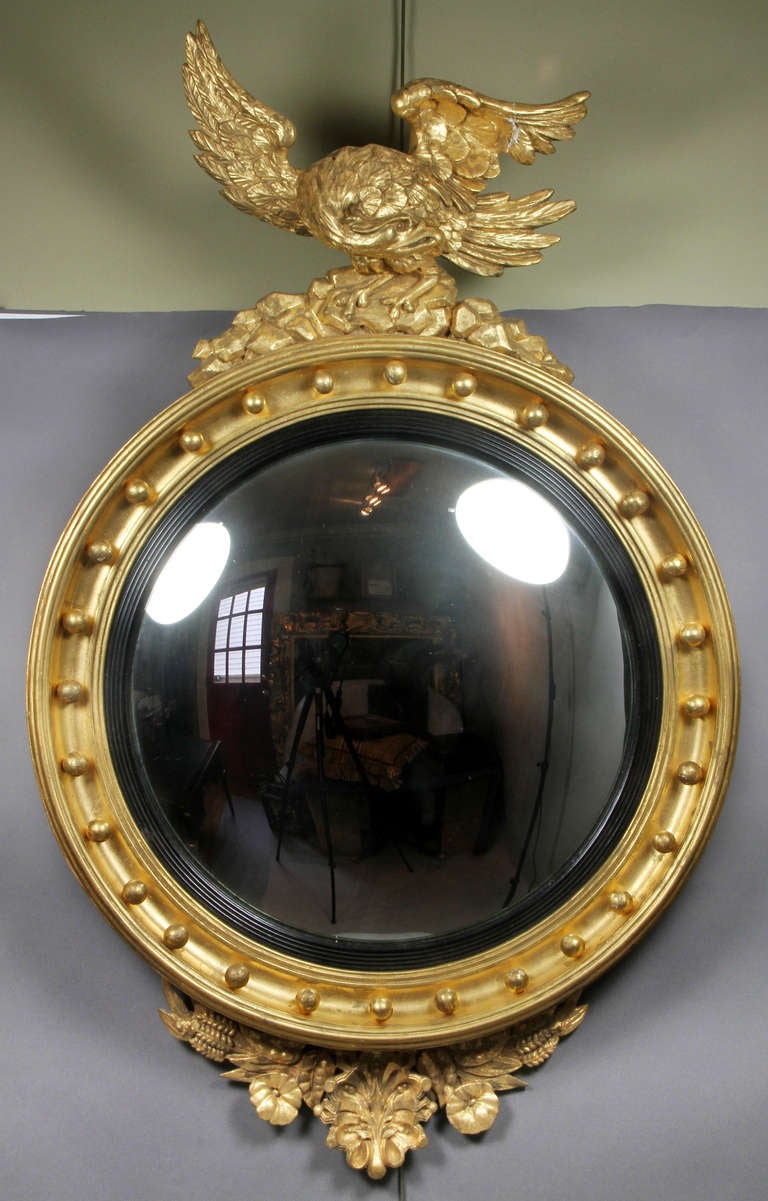 Circular convex plate within a molded frame with balls , eagle finial ,wheat and floral decoration on base.