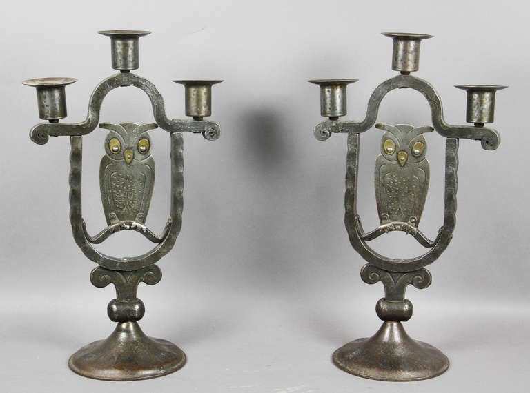 Each with two arms with central owl figure , circular base.