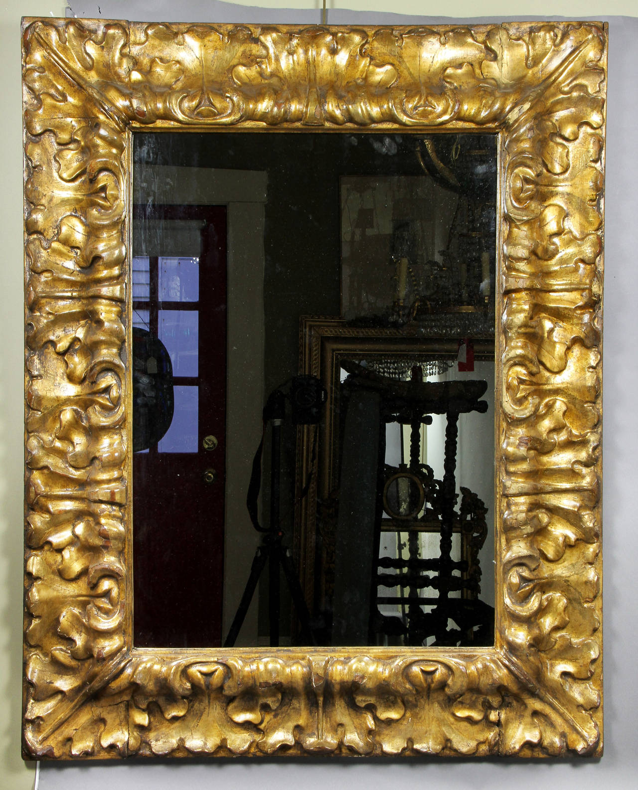 With new mirror plate , the frame carved wood , gesso and gold leafed . Carved acanthus frame.
