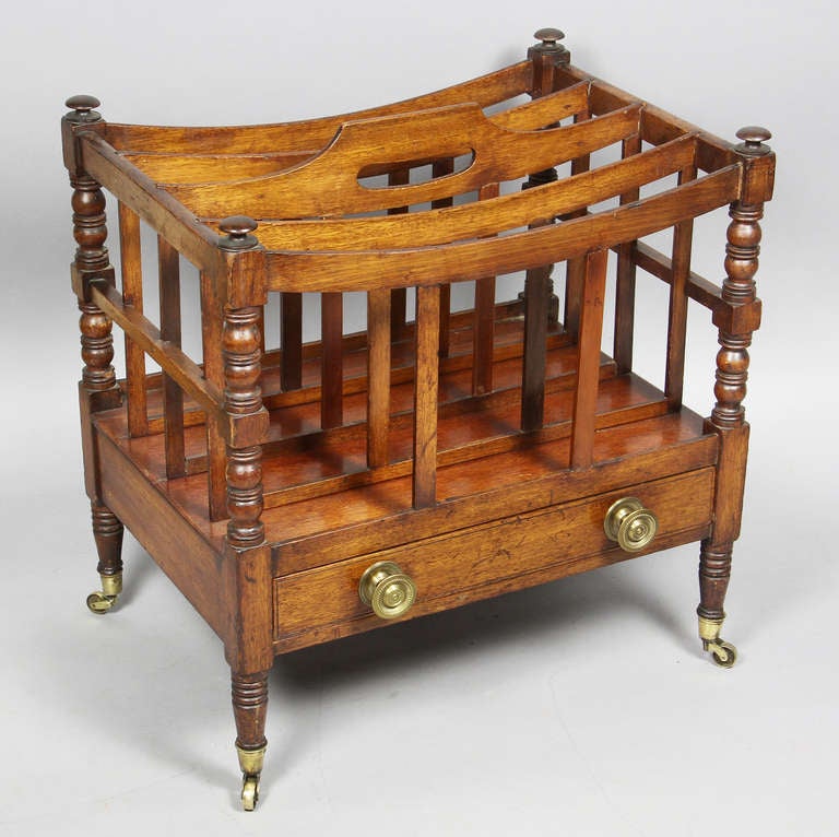 Rectangular with central handle , four slats over turned supports , with a drawer ,turned legs and casters.