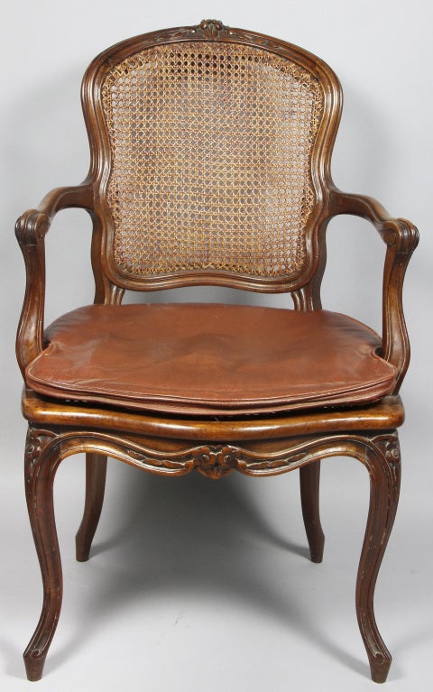 Each with arched caned back and serpentine caned seat raised on cabriole legs.