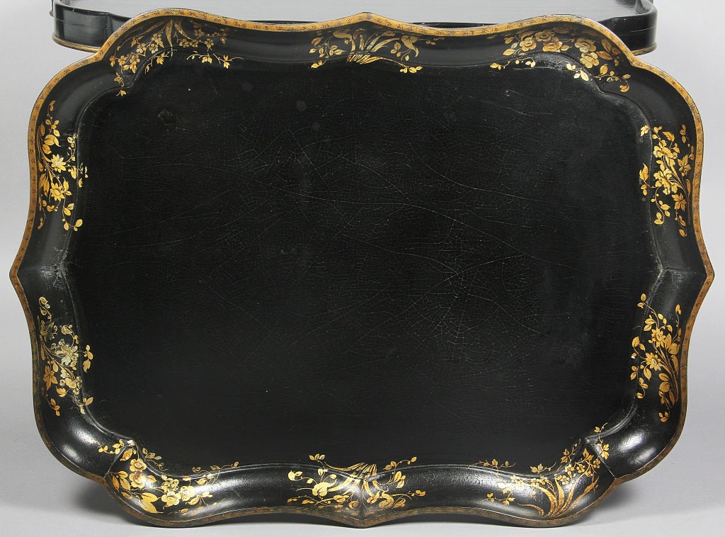 SHAPED SERPENTINE TOP DECORATED WITH GILT FLORAL DECORATION,TURNED LEG EBONIZED BASE WITH X STRETCHER.SIGNED CLAY,KING STREET,COVENT GARDEN