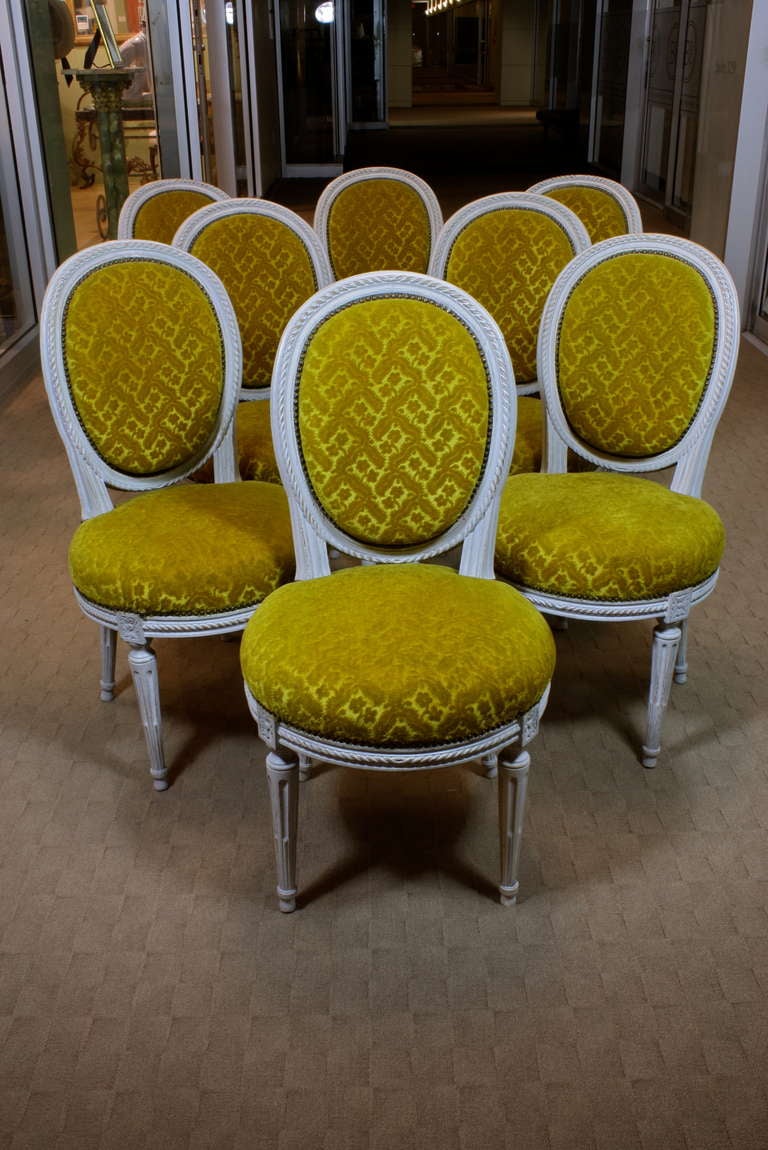 A lovely set of French grey-painted Louis XVI side chairs, with nicely-carved rope detailing, cabriolet back and cable-fluted legs.  Chairs have retained their vintage patterned wool mohair upholstery with brass studs.