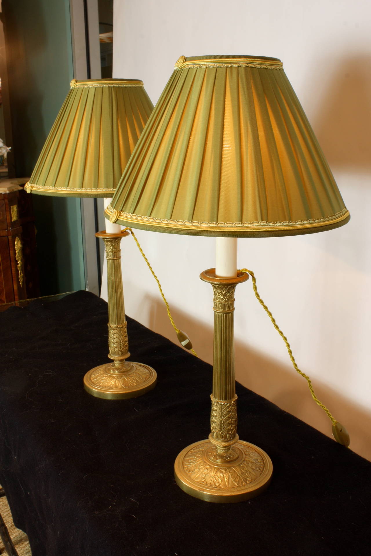 Pair of large French gilt-bronze Empire style candlesticks with finely-chased neoclassical detailing (Circa 1870), converted to lamps, with custom-made Paris silk pleated shades (12