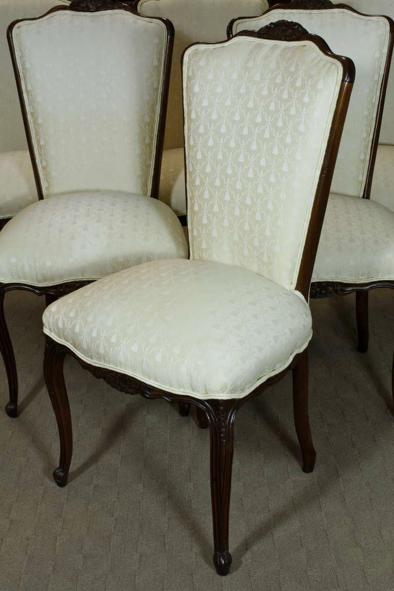 A nice set of six French high back upholstered dining chairs in the Louis XV style, with carved crest and seat rails, more recently upholstered in patterned white cotton fabric. See also our French Louis XV style dining table (listed item DLC1001).