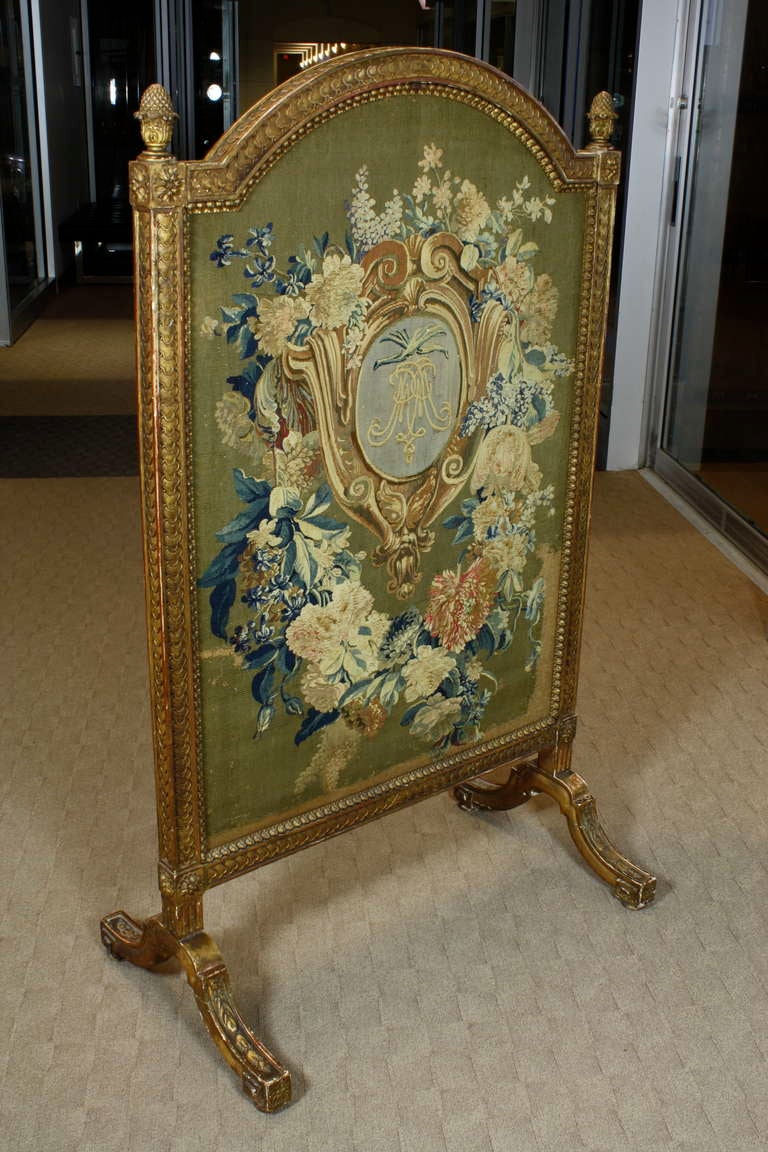 A lovely French giltwood fire screen with a highly-detailed needlepoint tapestry depicting a double 