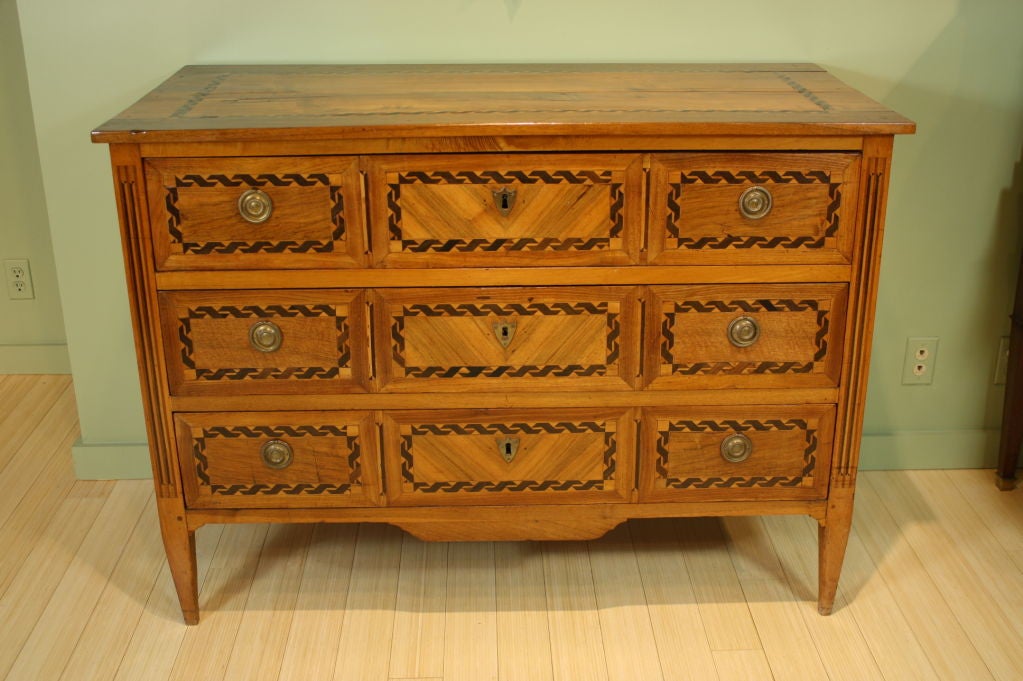18th century neoclassical commode from Northern Italy with banded marquetry around the perimeters of the drawers, top and sides.  Three drawers and bronze mounts.