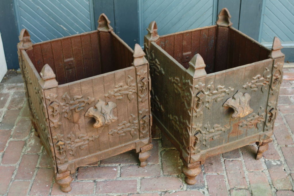 Pair of French cast-iron jardinieres in orangier planter form with ornate faux hinge detailing, handles and corner finials.