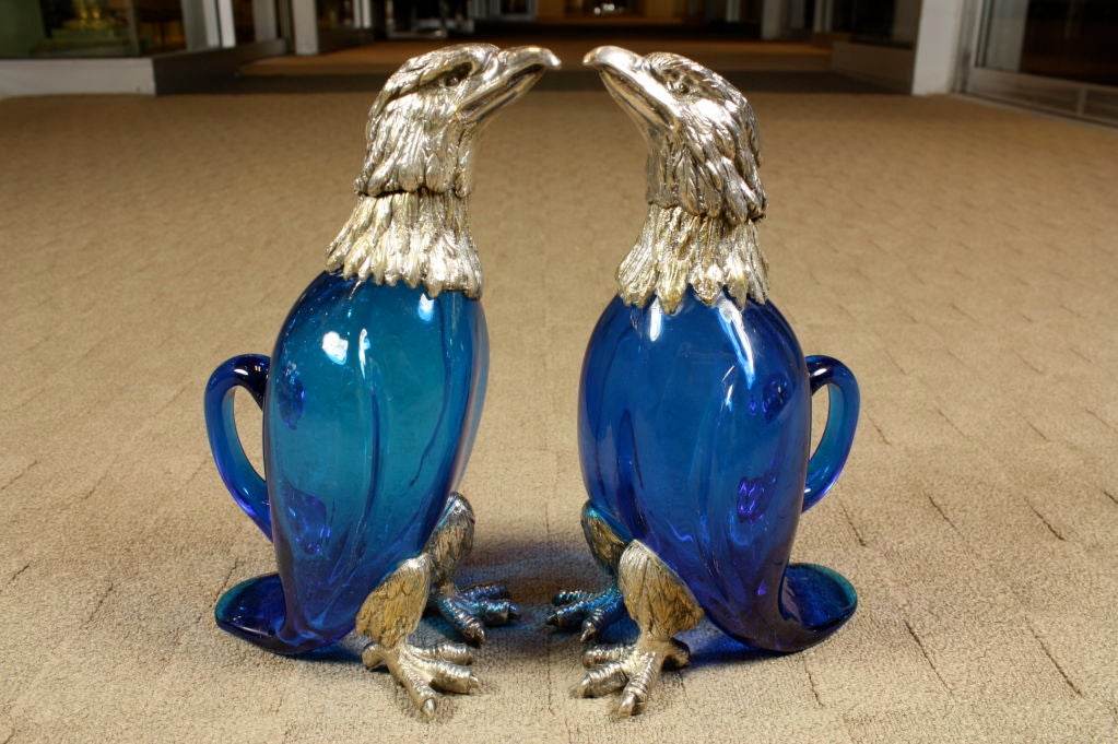Pair of beautiful French blue blown-glass decanters in the form of eagles, with finely-cast silvered-bronze heads and feet.  Heads open on hinges for pouring wine or other liqueurs.
