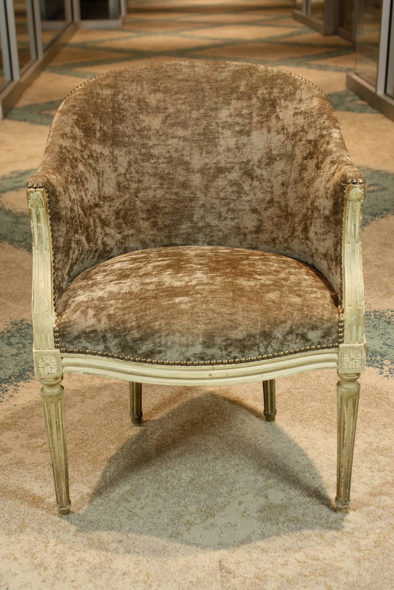 French Louis XVI style painted desk chair with new French velour upholstery and brass nail head trim.  The chair features unusual diamond shaped die joints with rosettes and fluted legs.