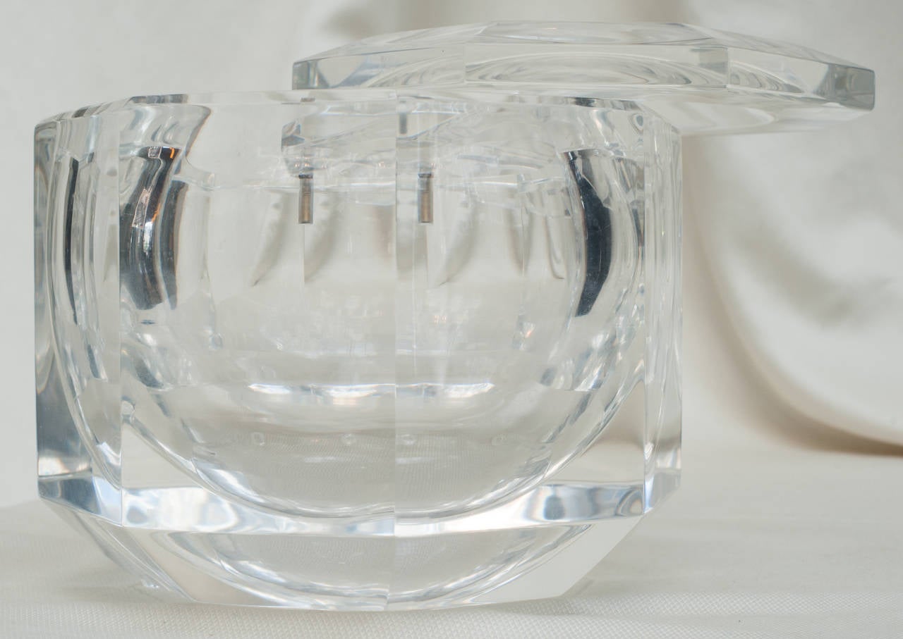 From the swinging sixties this large lucite ice bucket is attributed to the designer Baron Allessandro Albrizzi.  The lid is pivoted and easily swings completely around.  The top and body are faceted and hand polished.  This piece is essentially a