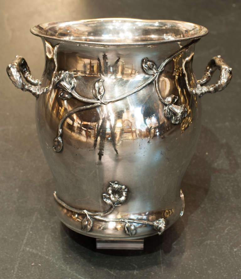 Art Nouveau champagne cooler in quadruple plate made by the Forbes Silver Company which was part of the Meriden Britannia Company of Meriden Connecticut.  The double handles are wrapped in leaves.  The  body of the cooler has a  morning glory vine