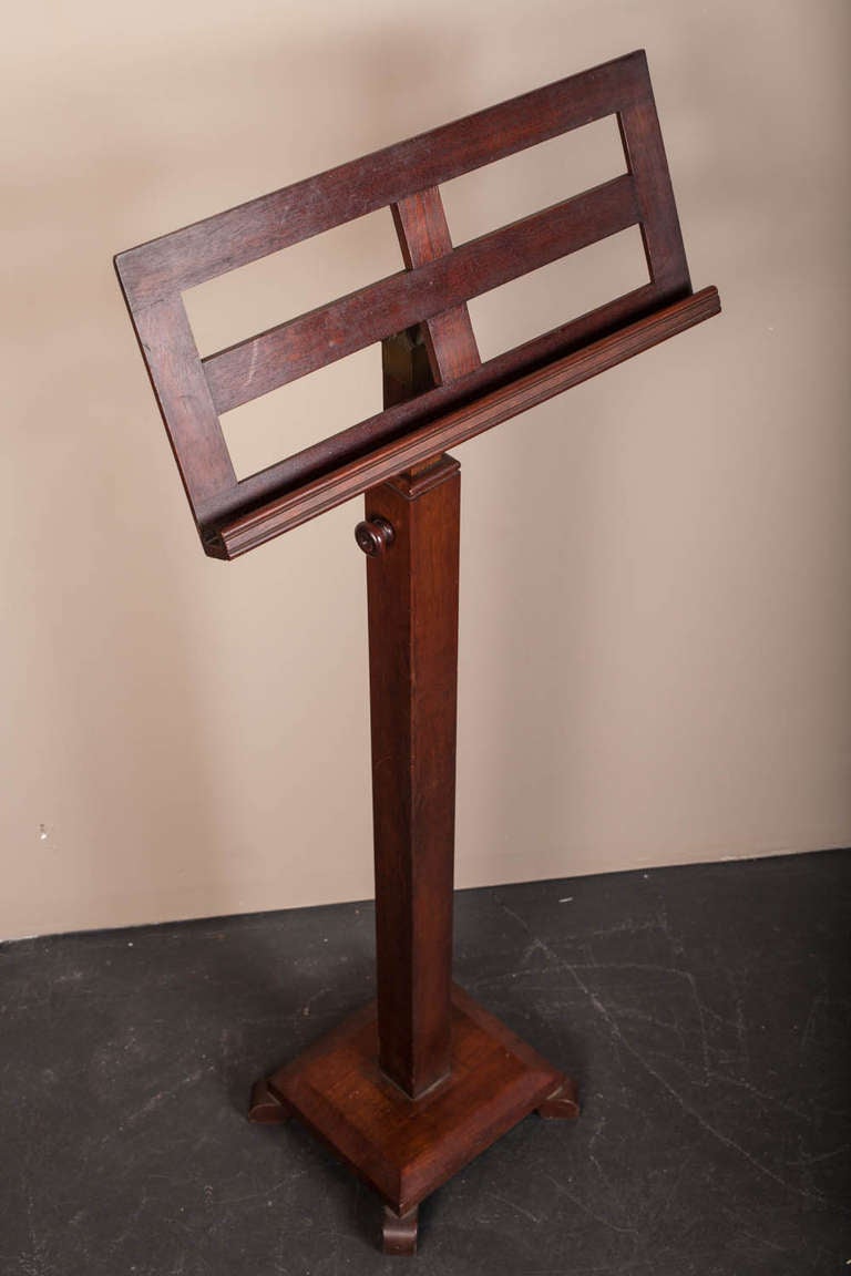Adjustable mahogany music stand.  The sheet music holder is adjustable from behind by means of a brass turn knob.  The stem or stand is adjustable by means of a removeable knob.  It can be used at 40