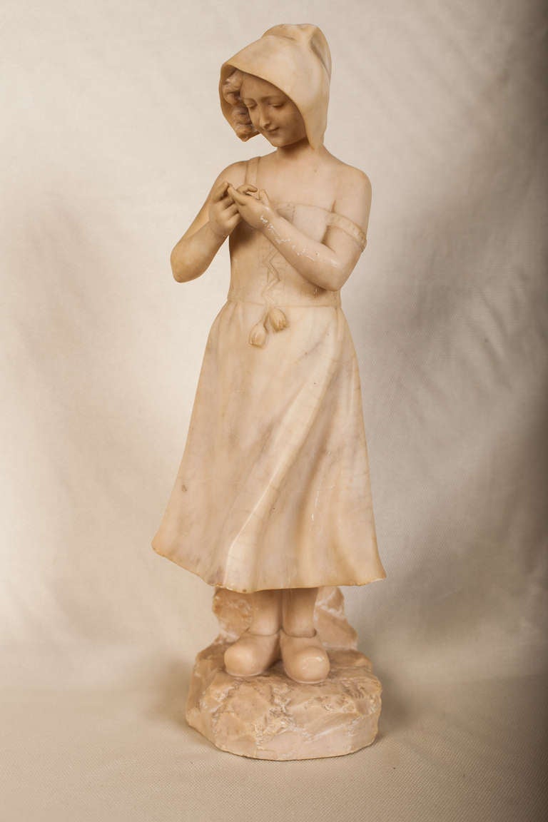Beautifully carved marble figure of a Dutch girl with a thorn in her finger.  Unsigned.