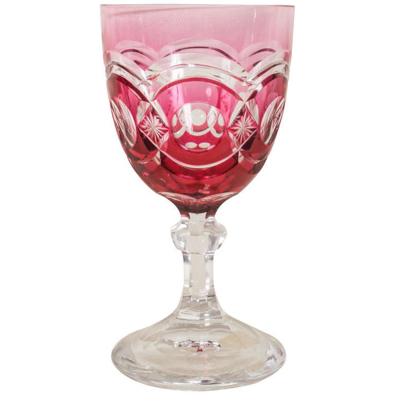 Set of seven (7) heavy cut crystal stemmed goblets. Each is overlaid in cranberry glass and cut back to clear (cranberry colored glass is created by adding gold to the mixture). The bottoms have large polished pontils.