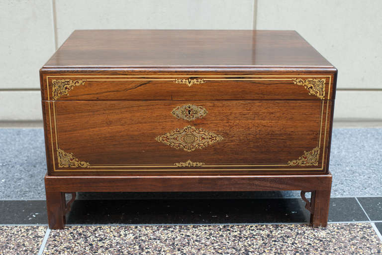 Antique rosewood French wedding chest made as a fancy and expensive gift for the bride. The rosewood chest has gilt bronze stringing and Boulle style inlay of mother-of-pearl and bronze. The military or Campaign style gilt bronze handles are flush