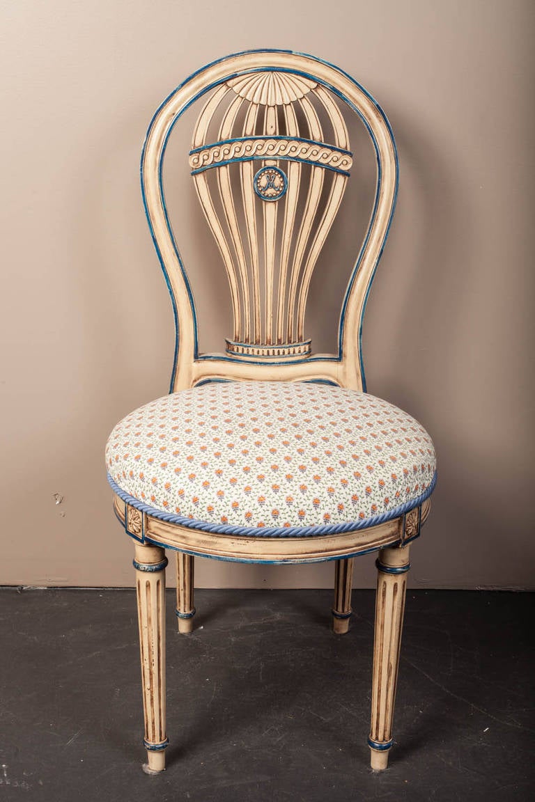 Louis XVI style Montgolfiere side chair in original cream paint with hand painted blue striping.  The back represents an ascension balloon and the legs are fluted columns typical of the Louis XVI period.  The back has two bolts that go from the legs