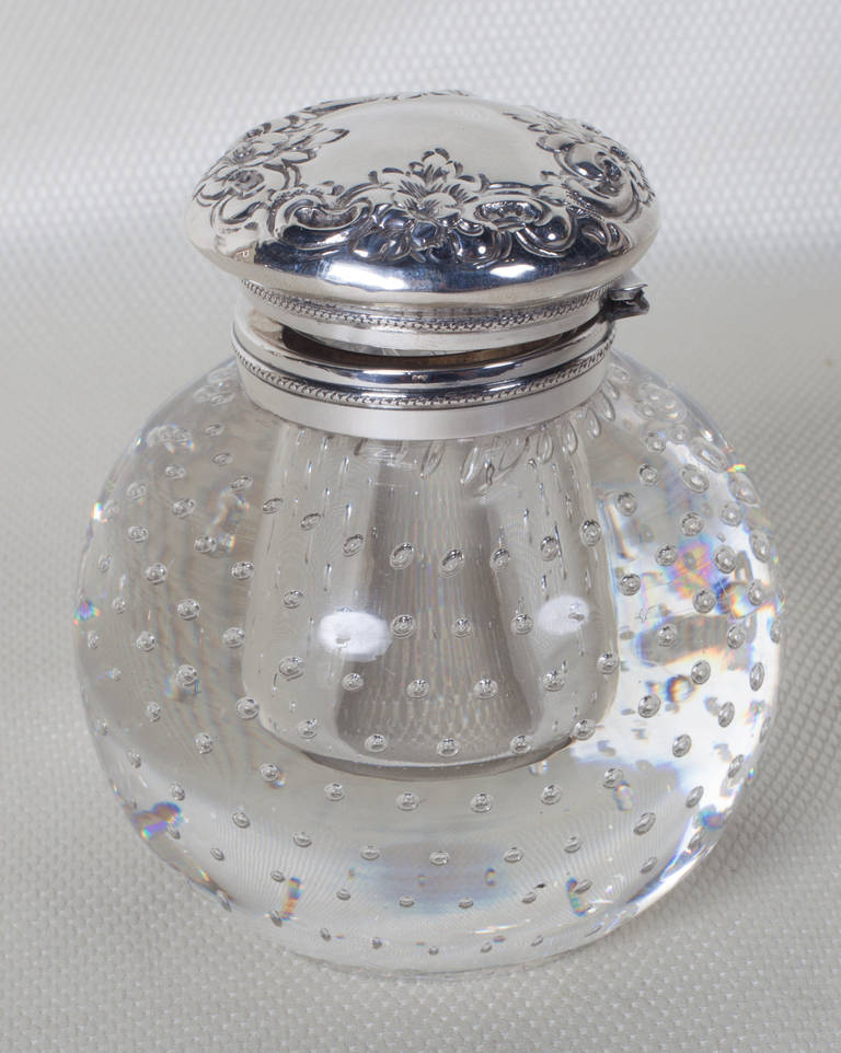 Pairpoint Glass Company ball shaped inkwell with the controlled bubble pattern that became synonymous with the company. The glass was blown around a molded form to create a receptacle for the ink. The bottom is ground. The sterling silver top is by