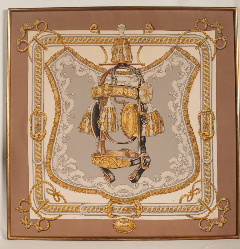 Hermès silk scarf in a gold frame designed by Françoise de la Perriere in 1969. It was purchased and framed at that time and remained in Paris until 1980 when it was brought to the U.S. It remains in excellent condition in strength and color. There