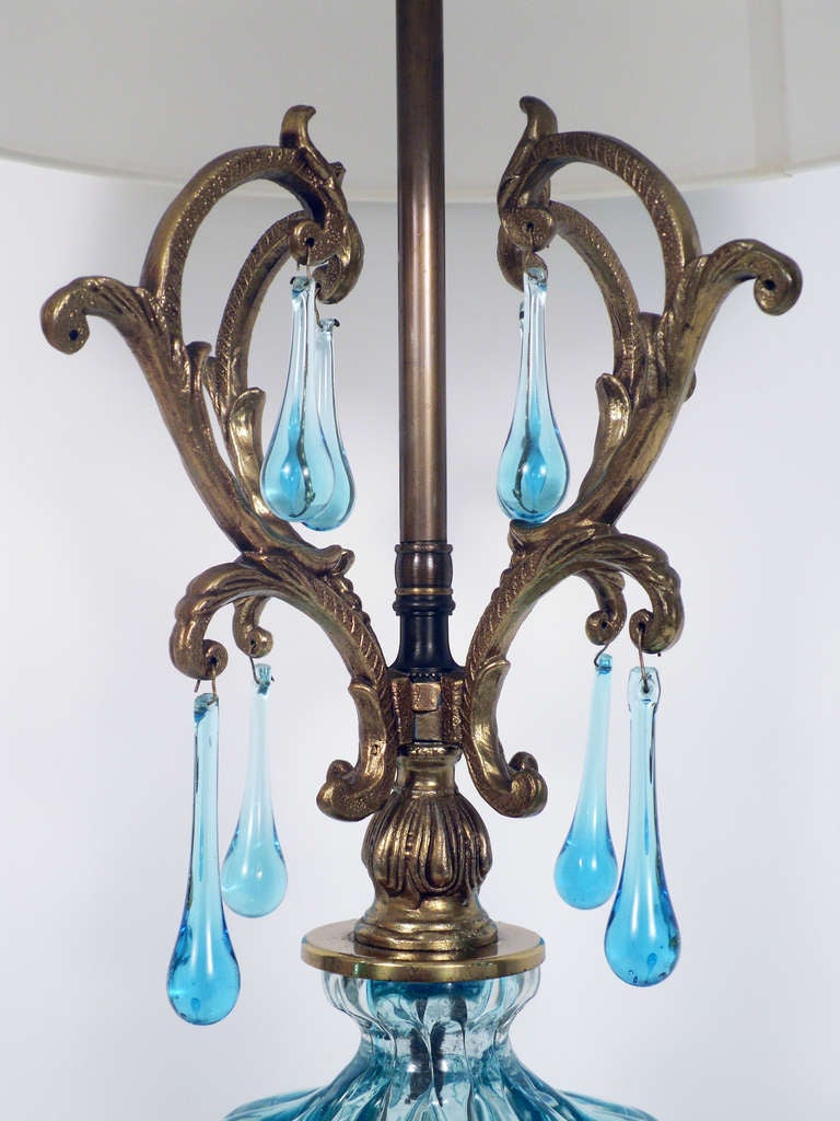 + A fanciful mixed materials lamp
+ Handblown central glass vessel complimented by metal and acrylic elements
+ Transparent 