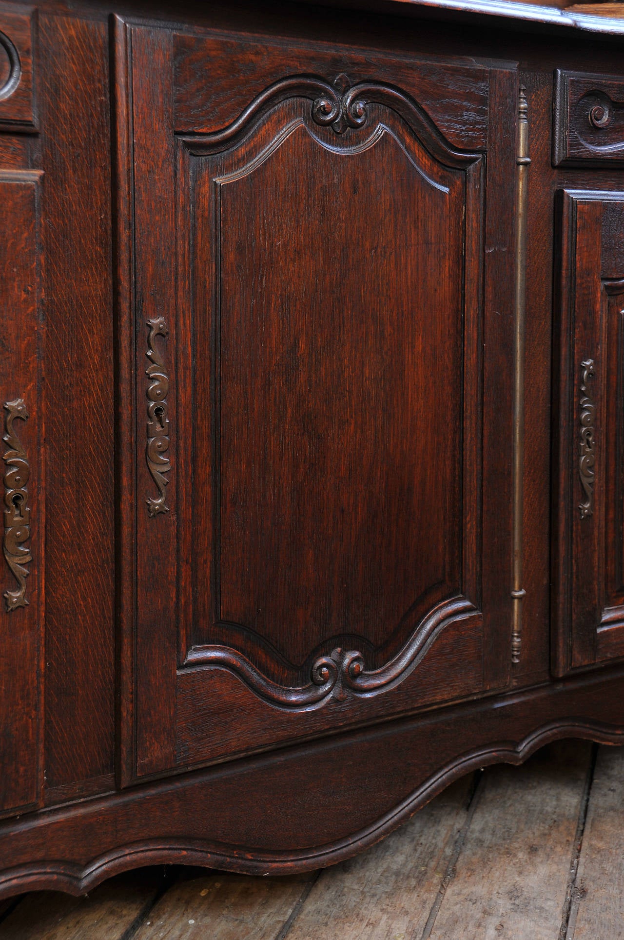 3 large raised paneled doors. 

2 silverware drawers.

Raised paneled sides. 

Carved top.