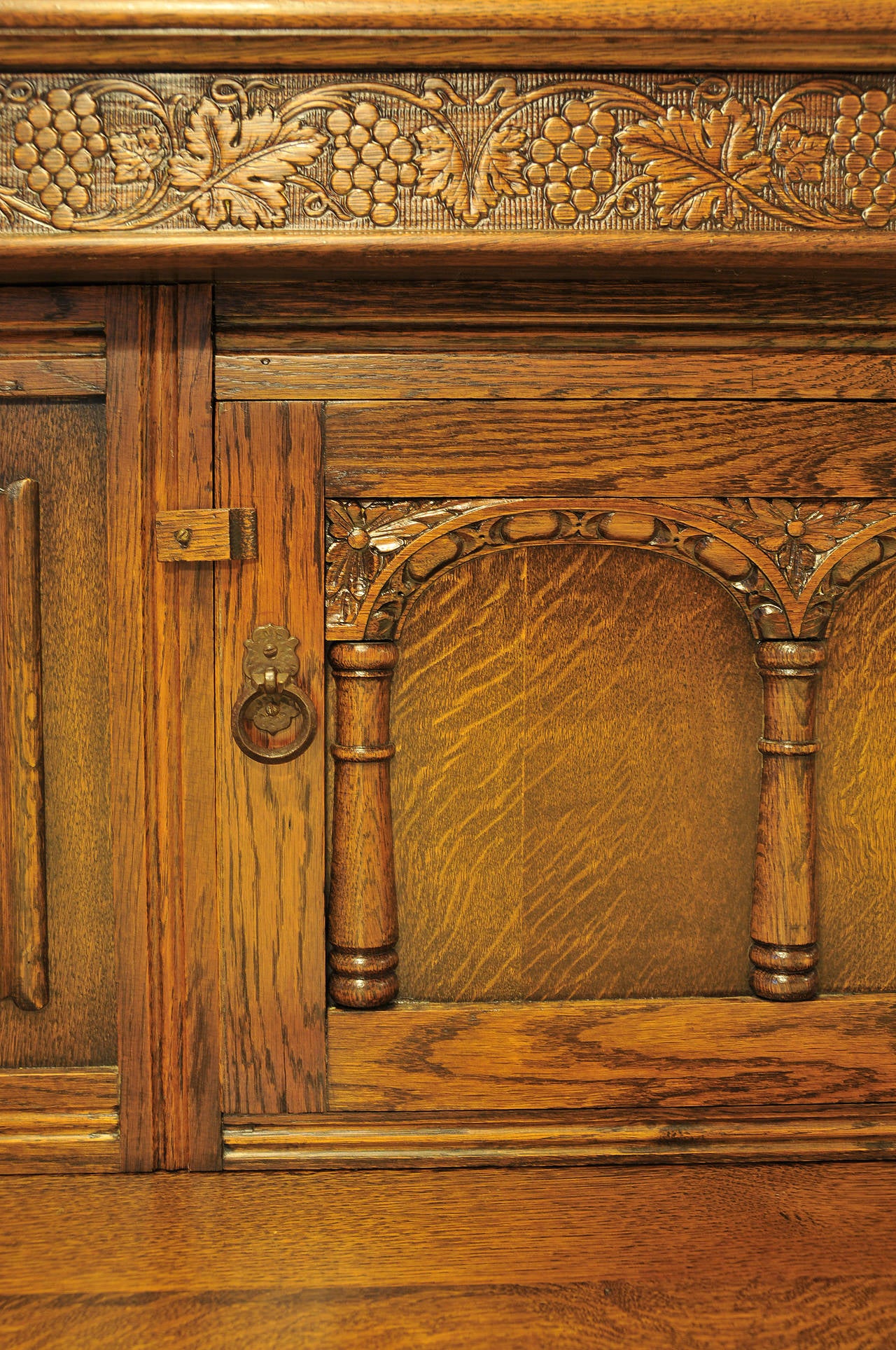 Step back top.

Carved upper door.

Two carved drawers. 

Two carved lower doors.

Linen fold panels made with beautiful tiger grain oak.