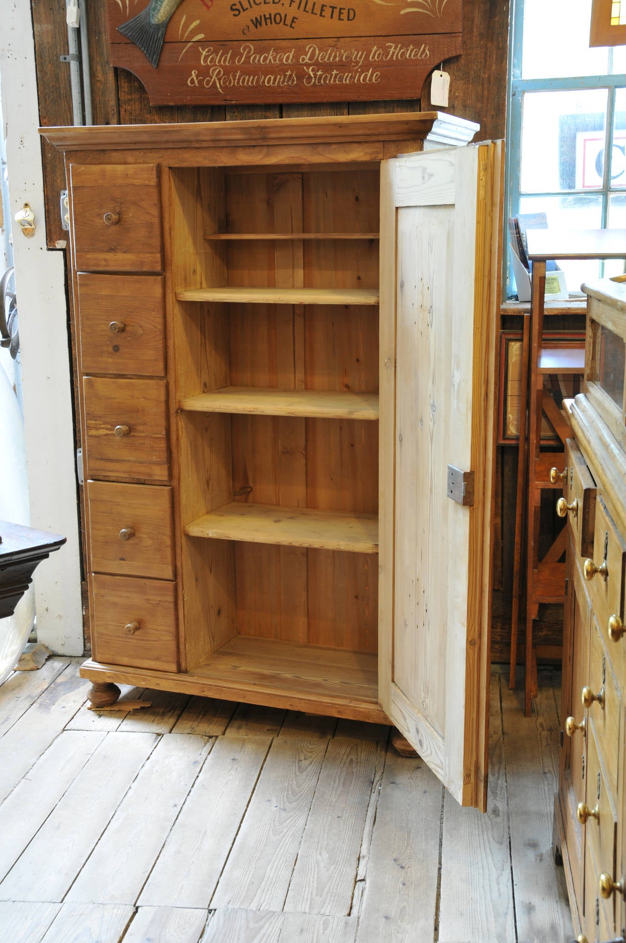 Five side drawers.

Large door with skeleton key lock. 

Four interior shelves.