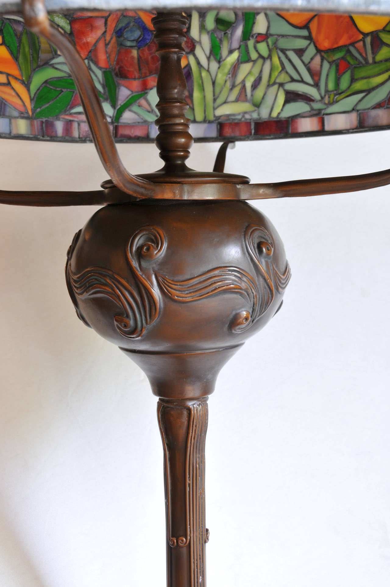 Leaded stained glass 

Bronze base 

Bronze finial top.