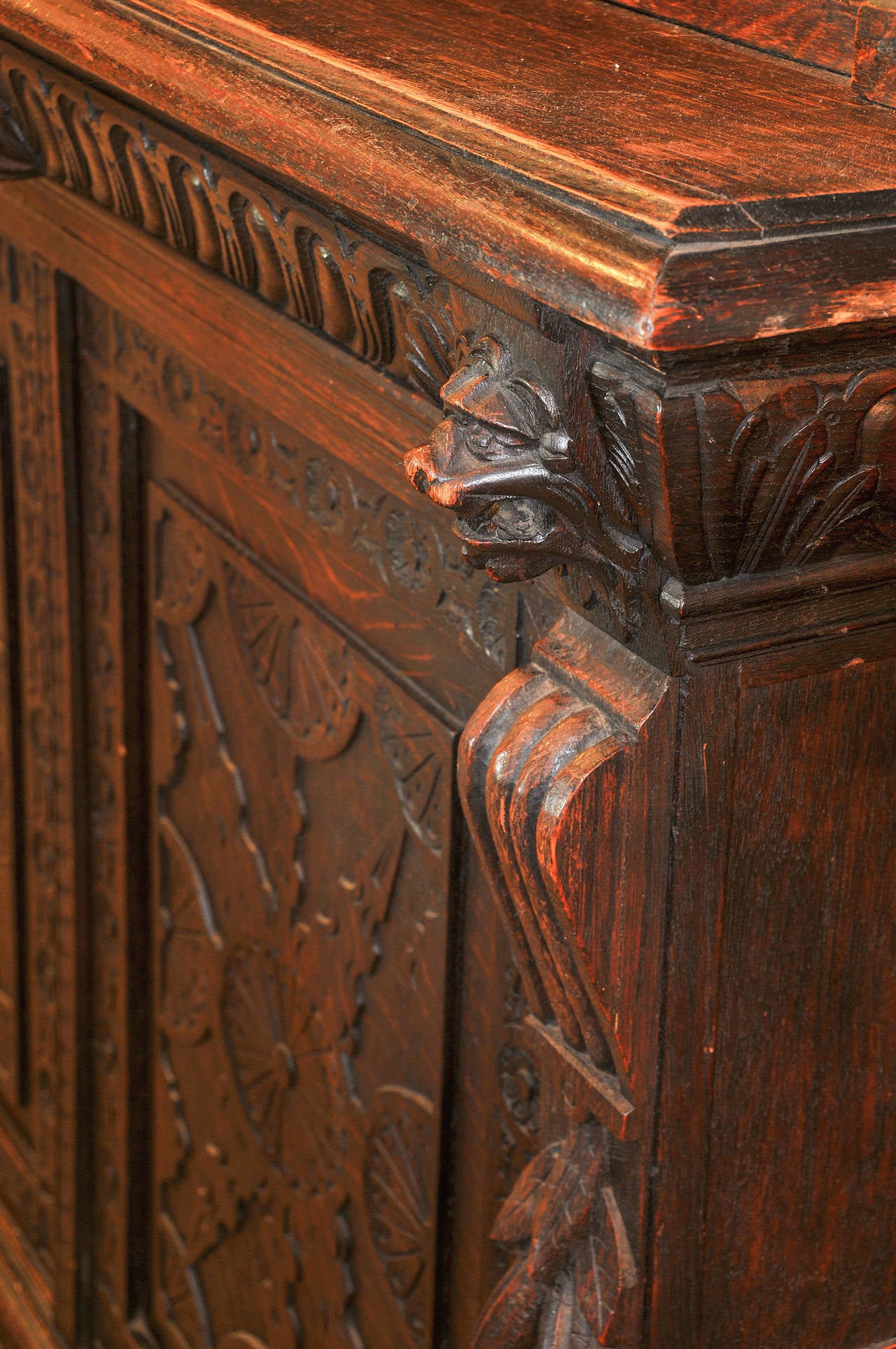 Victorian carved oak bookcase 

Five lion heads 

Four doors

Center drawer 

Exceptional Carved