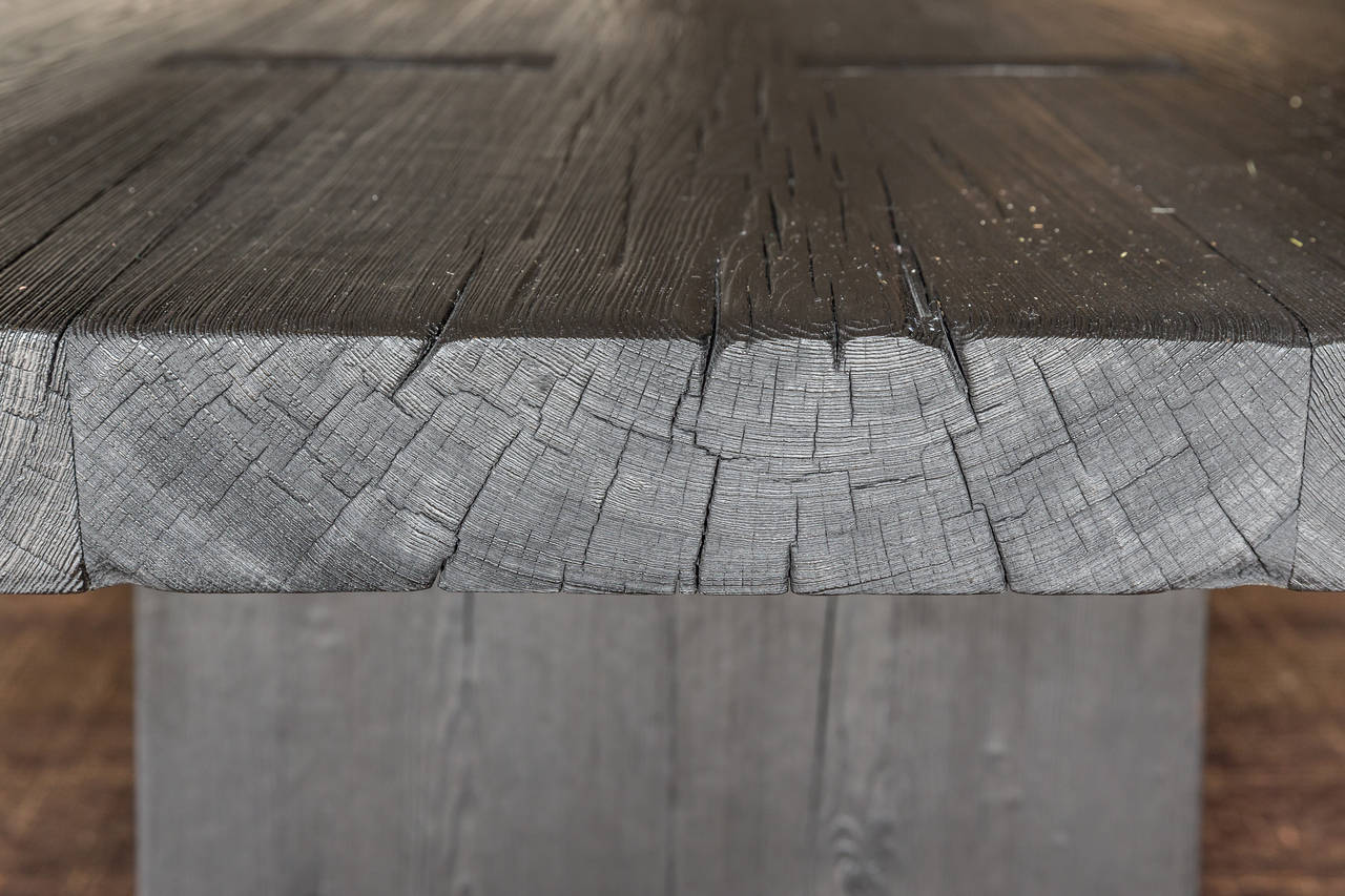 Modern slab leg table with structural butterfly inclusions in top.