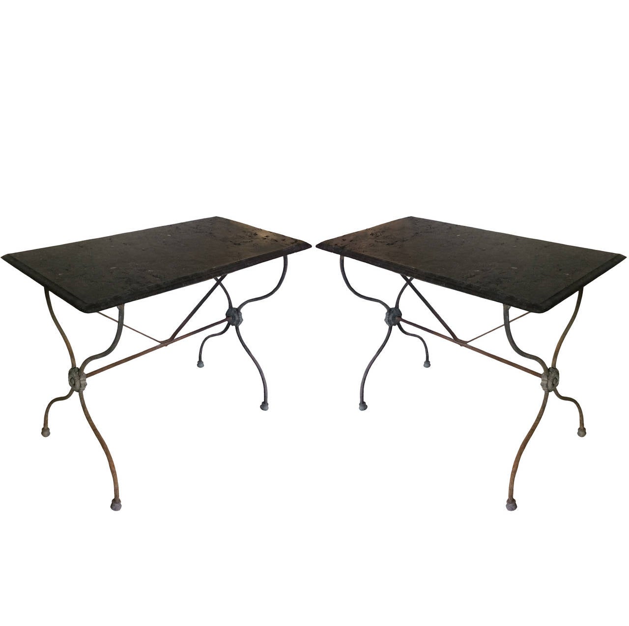 A pair of French Directoire style garden tables; petit granite stone tops; ogee edges; 19th century.