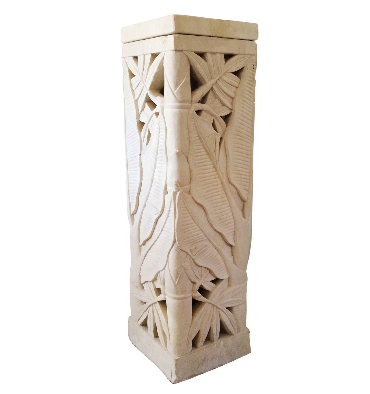 A pair of French Deco Pierre de Beaulieu stone pedestals from the French Riviera; circa 1925. A series of intricately carved leaves; pierced stone work; leading up to a stone cap. An up-light could be placed within for added drama.