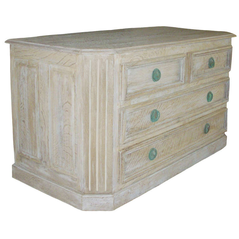 French cerused oak commode with four drawers; fluted columns; projected moldings; verdigris hardware; circa 1920.  Excellent condition.
