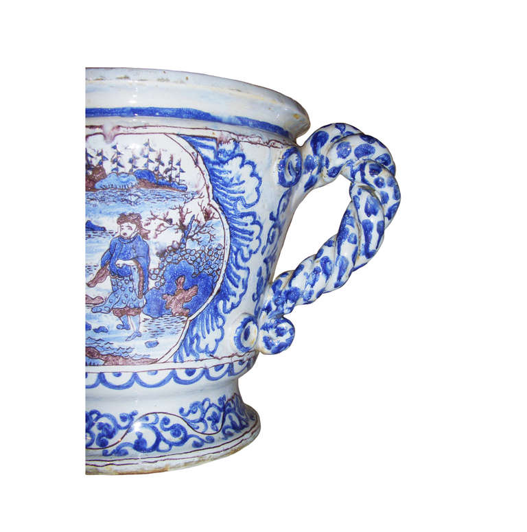 Blue and white never urn; central oriental scene; with twisted scroll handles; 18th century.
