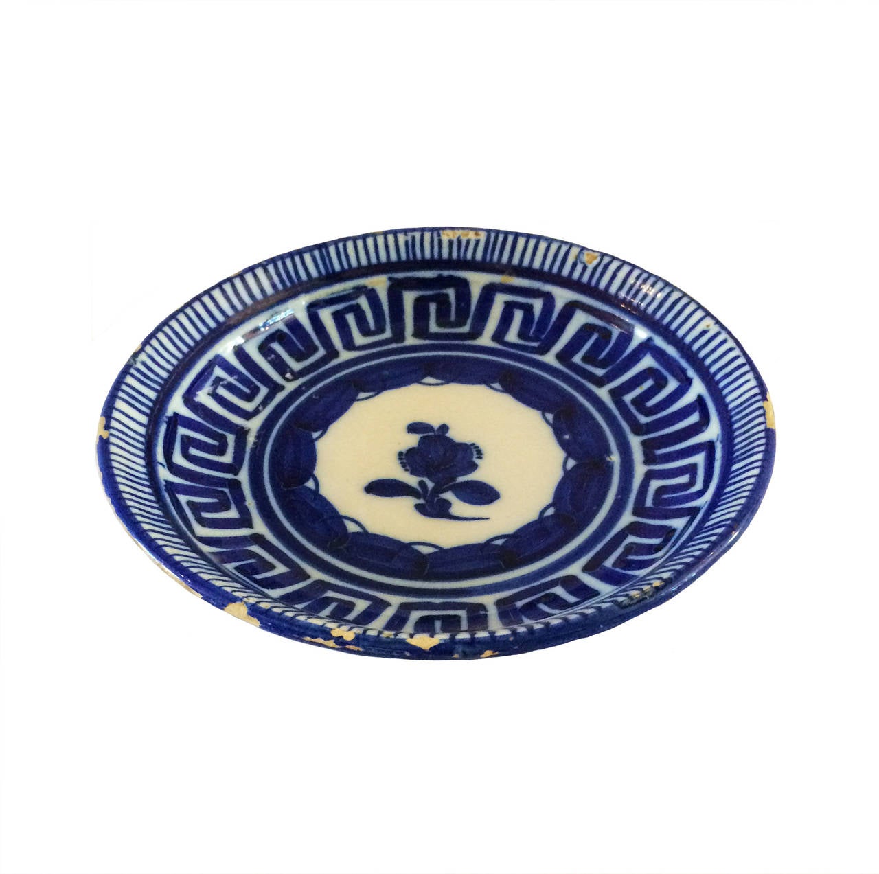 18th century blue and white plate with a predominant Greek Key border and center flower.