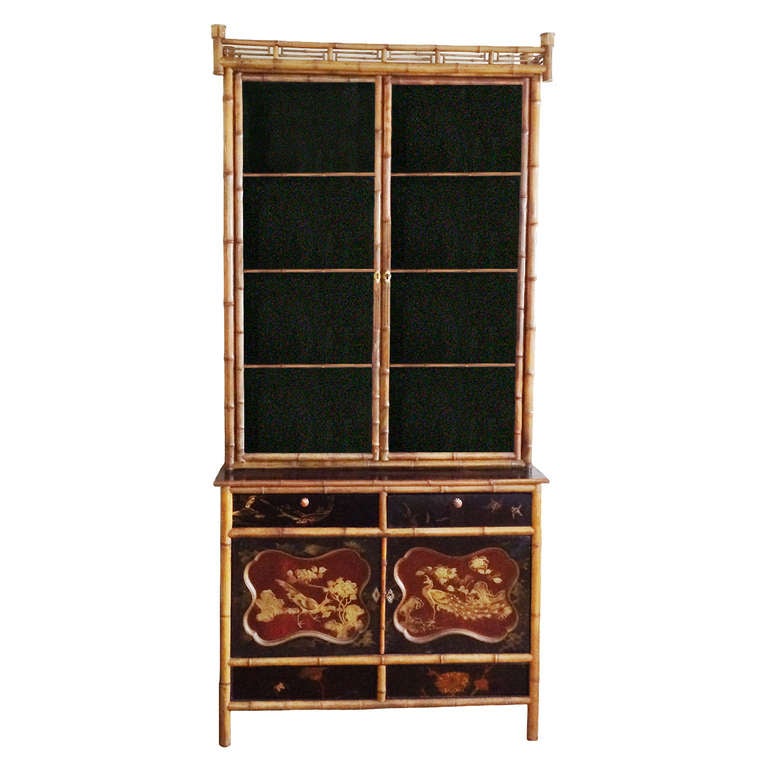 English chinoiserie cabinet; japanned raised lacquer with oriental decoration; bamboo frame and intricate cornice; four doors and two drawers; 19th century. Stunning recessed central panels on lower cabinet doors. Excellent condition.