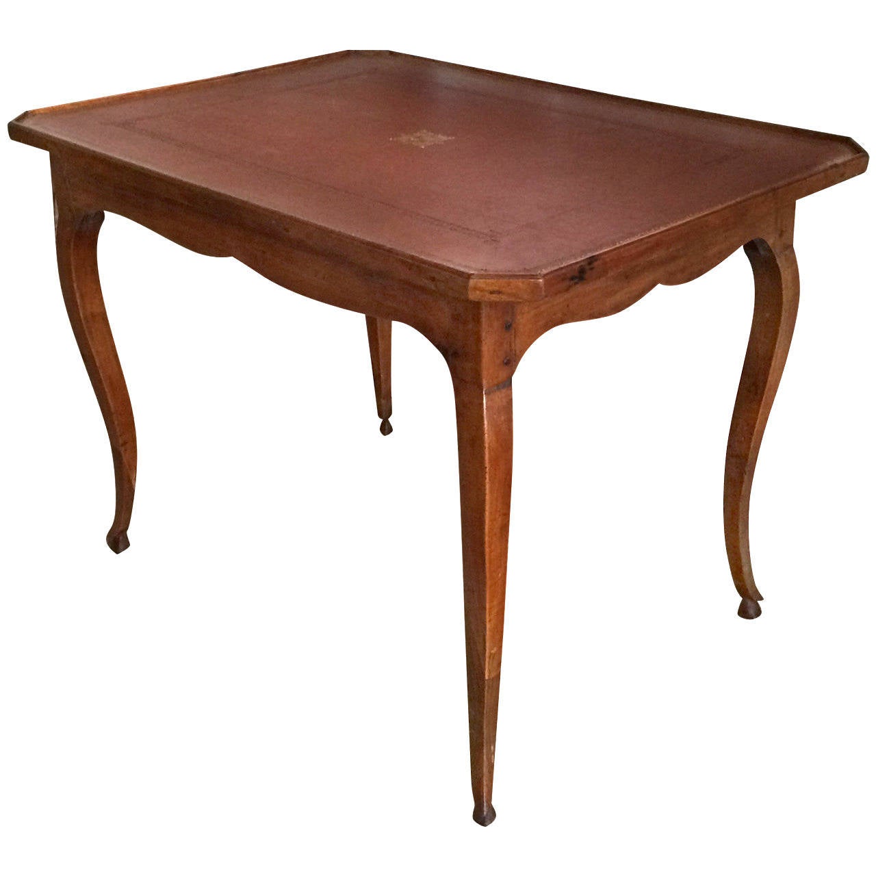 18th century Louis XIV style cherrywood writing table, stenciled leather inset with a centre medallion.