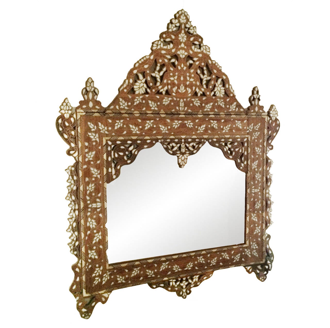 19th century exceptional Syrian mother-of-pearl inlay mirror with a series of framed bone borders; scalloped cut-out details; center dome. Fabulous patina!
