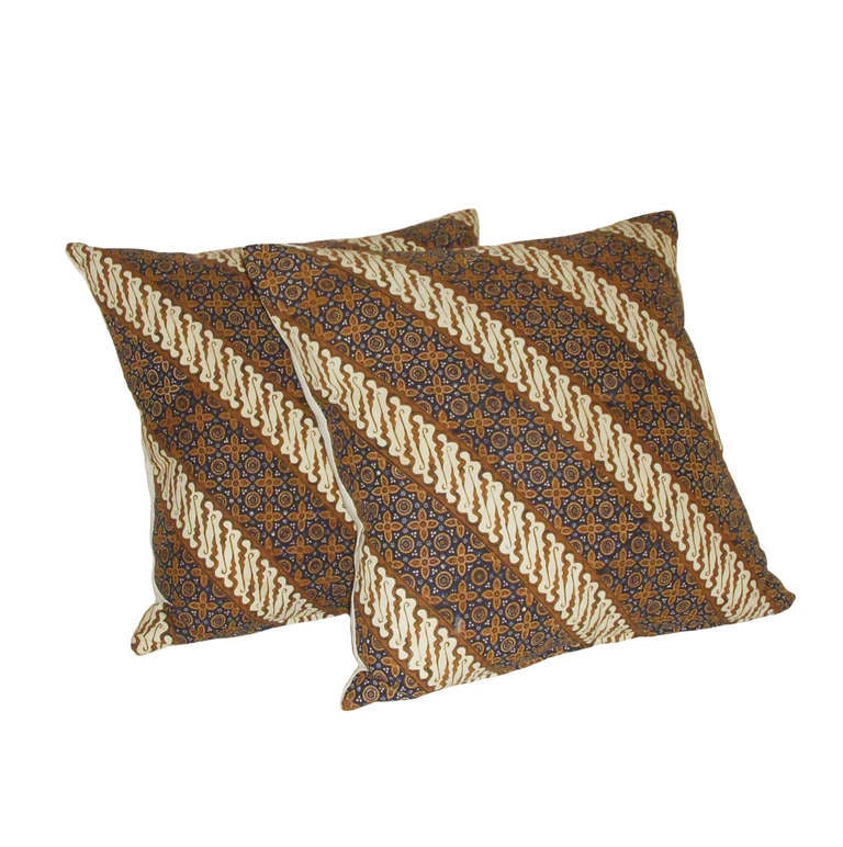 A pair of custom vintage Indonesian Batik down pillows; brown, indigo, beige. Geometric diagonal pattern with small floral medallions; 19th Century.