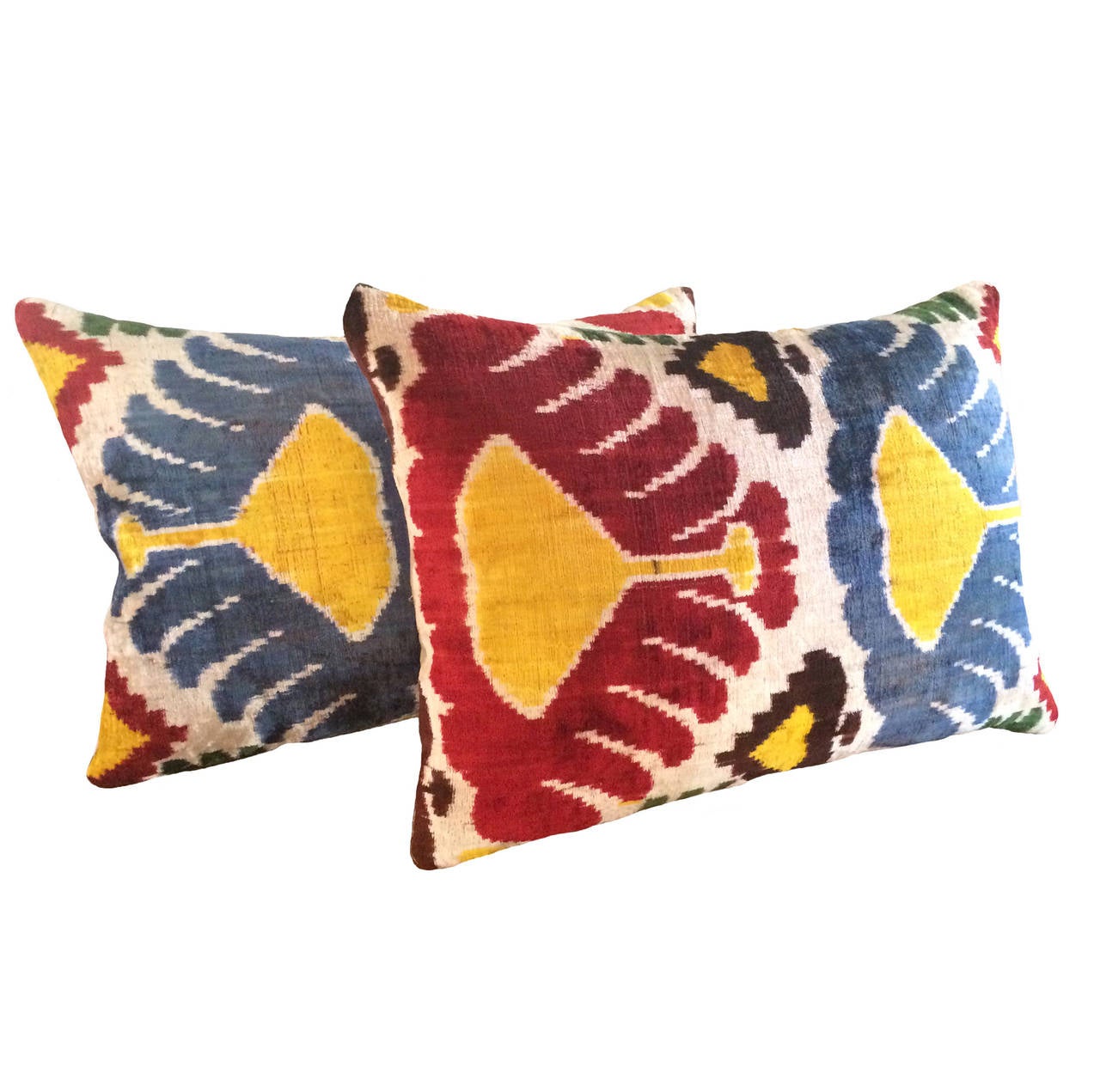 Pair of custom flamme silk velvet ikat down pillows; red, blue, yellow on ivory ground, 19th century.