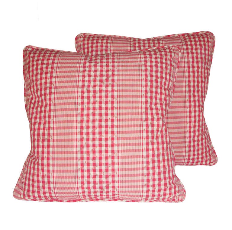 Pair of custom red gingham check down pillows with matching piping, on both sides; 20th century.