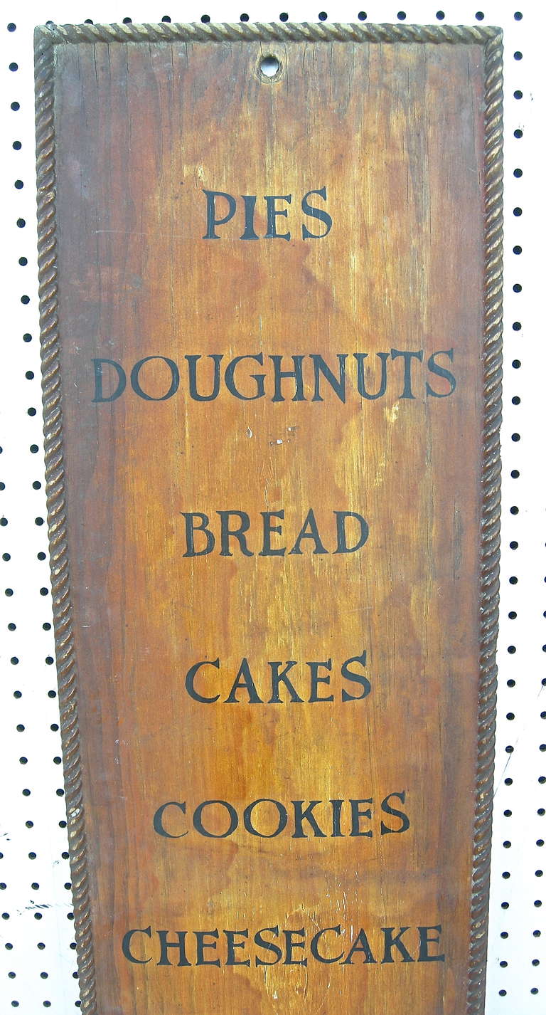 A handsome vintage, Midwestern bakery menu board. Original hand painted lettering with additional artful detailing.  Warm time worn overall surface and patina.