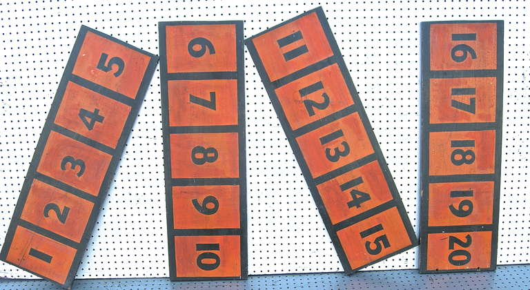 An eye-catching quartet of, vintage carnival,  numerical game boards. Having bold hand painted lettering with striking red/orange backgrounds.
