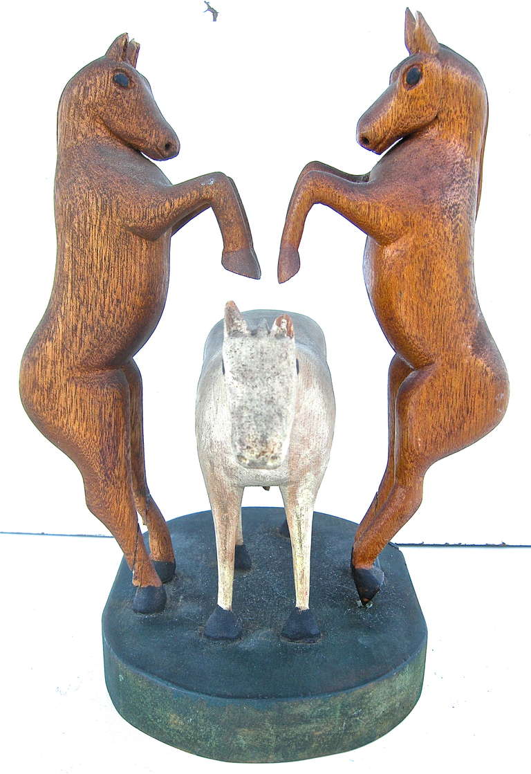 A delightful, vintage, folk art, wood carving of 3 mischievous horses involved in the rare and seldom seen 