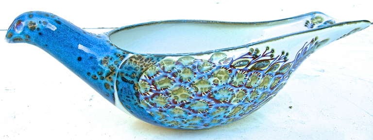 A beautiful, decorated, Royal Copenhagen fajance sauce boat. Designed by Berte Jessen, 1970, featuring a sculpted peacock design and form, with textured feathers with artisan flare. In gorgeous colors of blue, teal and lilac. Maker's mark to bottom,