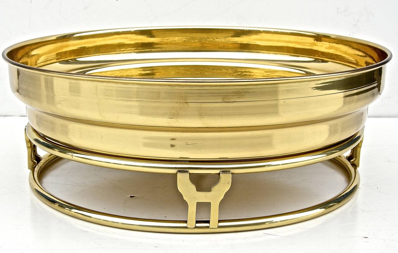 Beautiful, vintage, two-piece brass fruit or center bowl. Having a highly stylized, modernist shape and feel. Striking round, lift off bowl or container atop a double ringed platform base with hieroglyphic style accents. Subtly elegant.