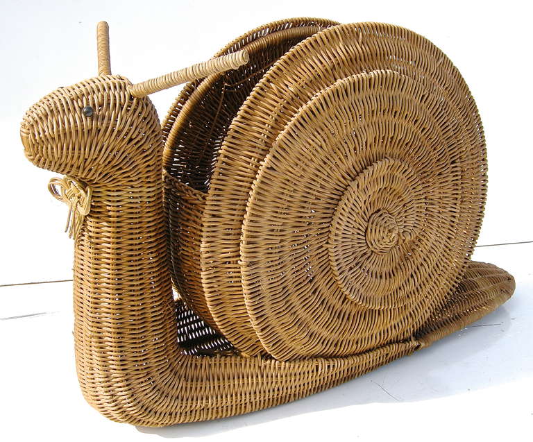 Whimsical vintage, wicker periodicals holder/rack, in a slow-moving snail motif.