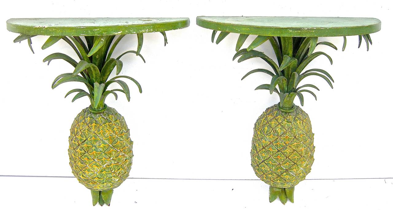 Striking pair of vintage, tole-painted wall brackets with elegant pineapple motifs.
Original paint with semi-distressed finish and warm patina.