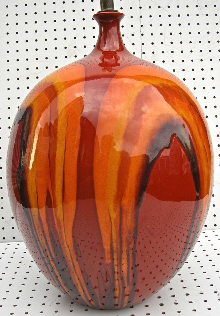 A striking, overscale Mid-Century, Danish light in a vibrant drip glaze motif. Having an eye catching inferno red and orange overall color palette.