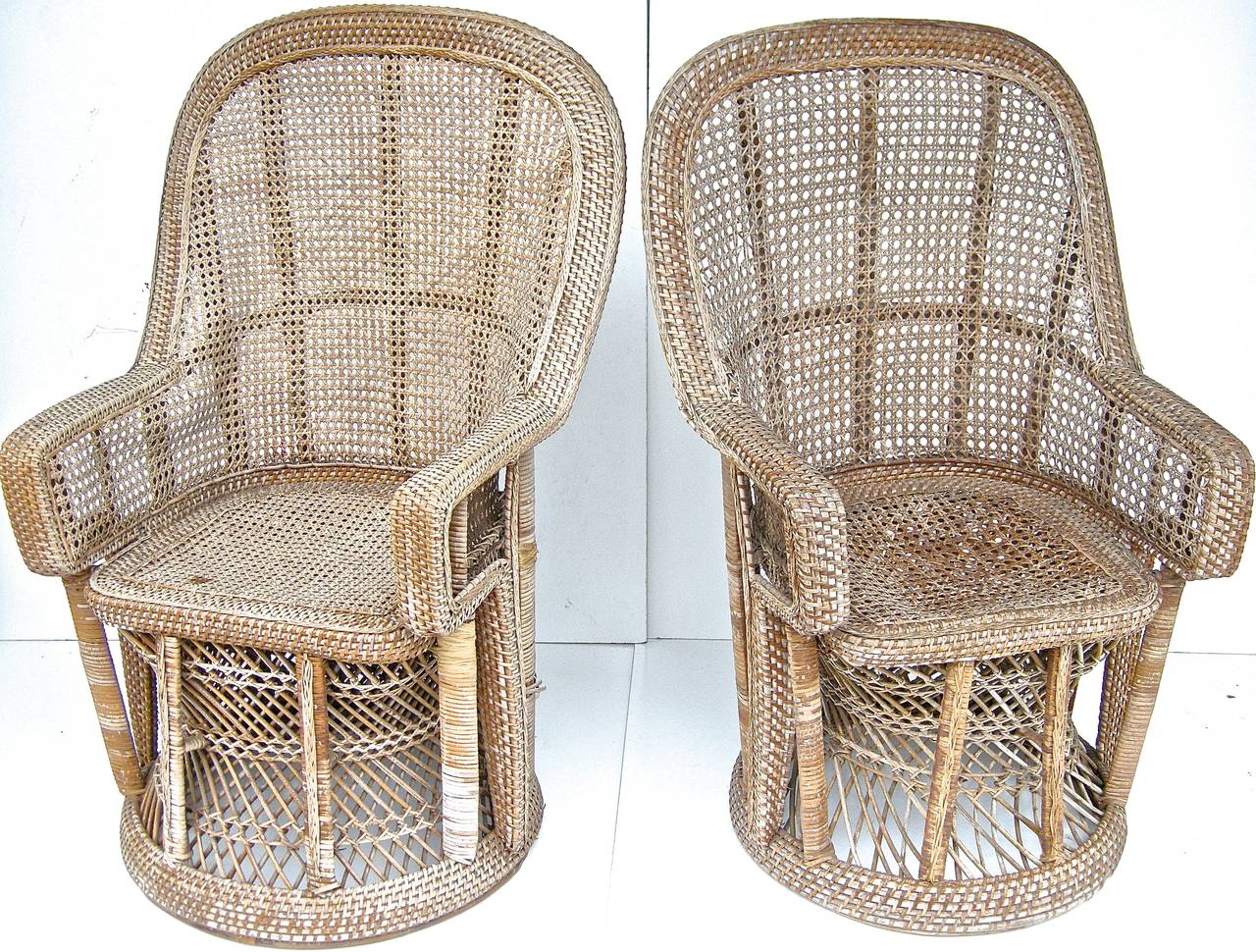 A handsome pair of vintage, woven and wrapped wicker armchairs in the Moroccan manner and taste, elegant diminutive shapes and forms. Beautiful aged surfaces and patina. Original manufacturers copper tag on verso.